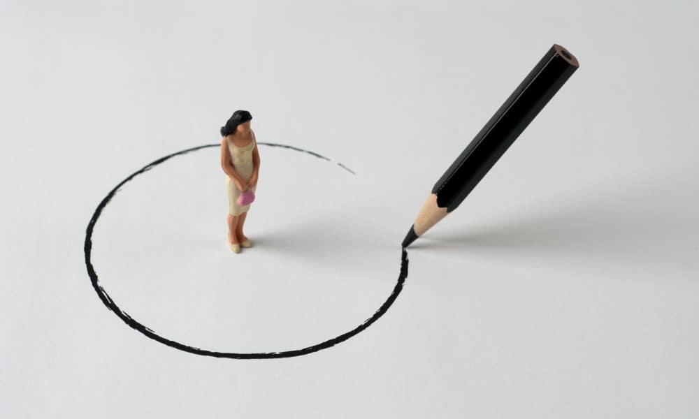 A pencil drawing a circle around a figure of a woman.