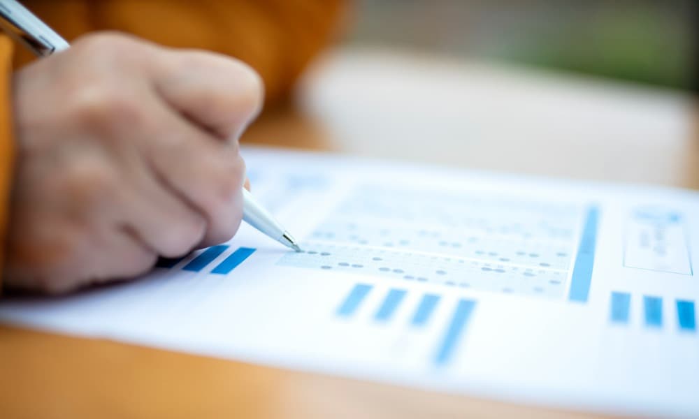 A person taking a test by filling in the answers on a sheet of paper.